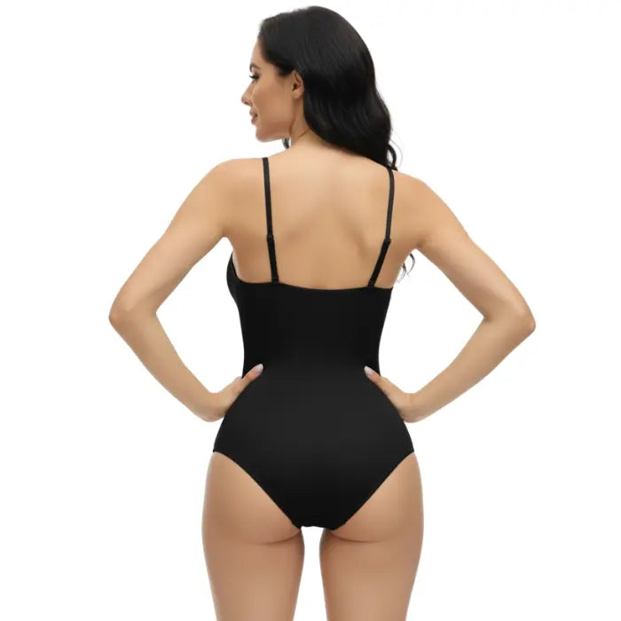 Clean back view of black shapewear underwear bodysuit on model with white background, seamless cut.