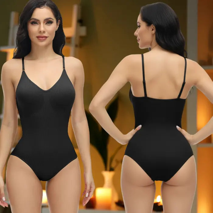 Black shapewear underwear bodysuit shown front and back in cozy, softly lit lounge room.