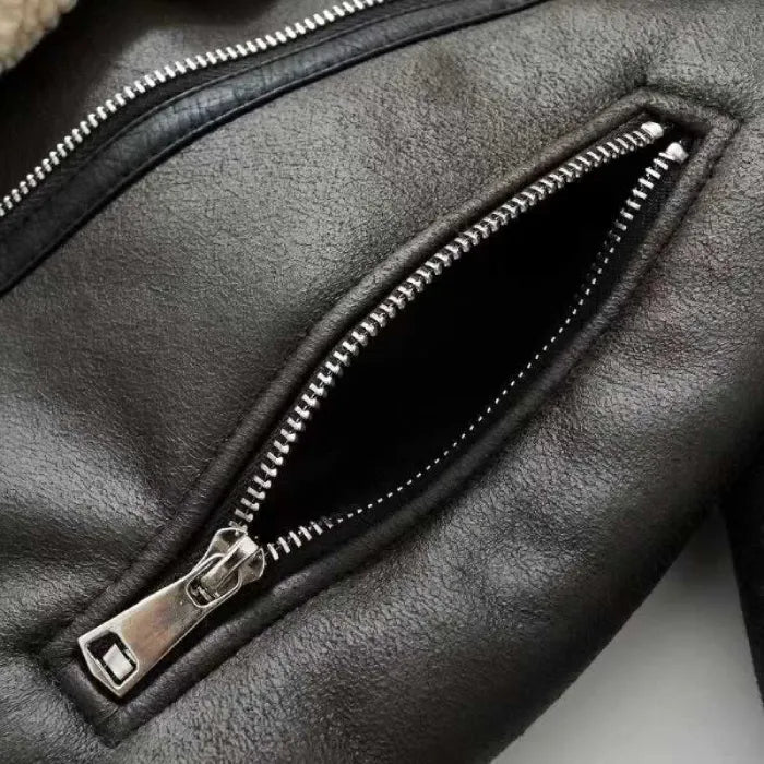 shearling-jacket zipper close-up featuring metallic hardware and textured leather surface highlighting durable winter coat construction