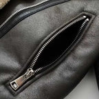 shearling-jacket zipper close-up featuring metallic hardware and textured leather surface highlighting durable winter coat construction