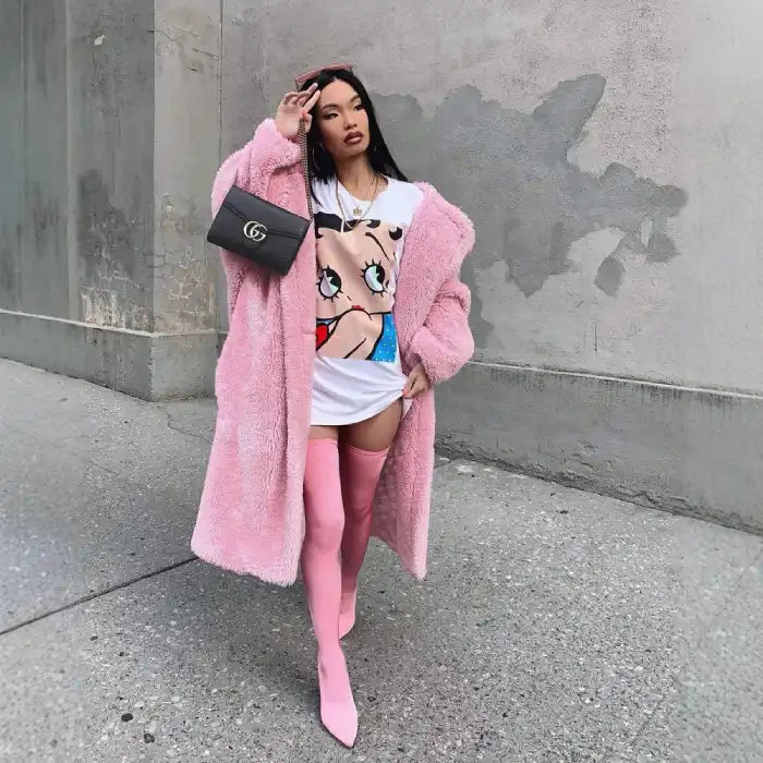 .sherpa coat in bubblegum pink styled with graphic tee and thigh-high boots for edgy street fashion.