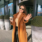 Sherpa Coat in camel with open front, styled with a beige top and black pants outdoors.