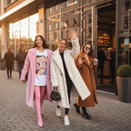 Trio of women in pink, white, and camel Sherpa Coats walking outside with coffee and smiles.