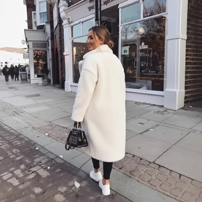 White Sherpa Coat back view paired with black leggings, white sneakers, and a chic handbag.
