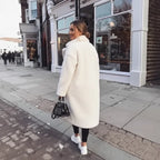 White Sherpa Coat back view paired with black leggings, white sneakers, and a chic handbag.