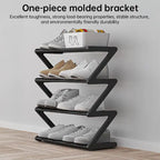 Shoe rack with modern Z-frame design and multiple tiers for organized shoe storage near a wall.