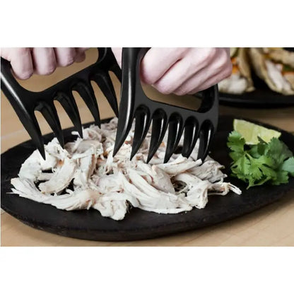 Shredding chicken using black meat claws, perfect for efficient meat handling and food preparation.