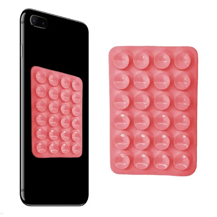 Pink silicone phone holder with suction cups displayed on a smartphone, providing firm attachment for hands-free mobile viewing