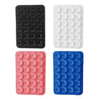 Set of silicone phone holders featuring strong suction cups in black, white, pink, and blue for secure hands-free phone support