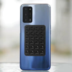 Silicone phone holder with suction cups attached to the back of a smartphone, providing stable support for hands-free daily use