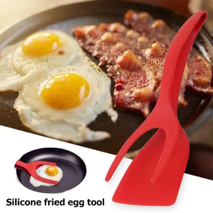 Silicone spatula beside bacon and sunny-side-up eggs in a frying pan, perfect for breakfast cooking.