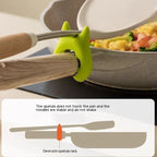 Silicone Utensil Holder keeping spatula raised above pan for stable cooking