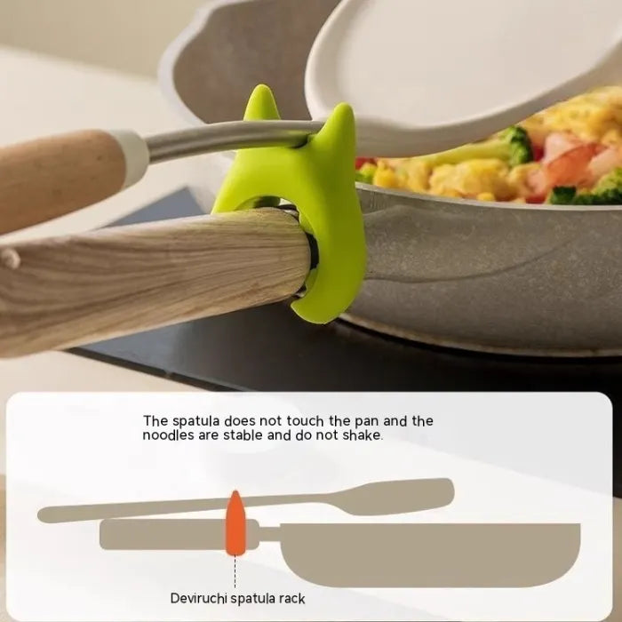 Silicone Utensil Holder keeping spatula raised above pan for stable cooking