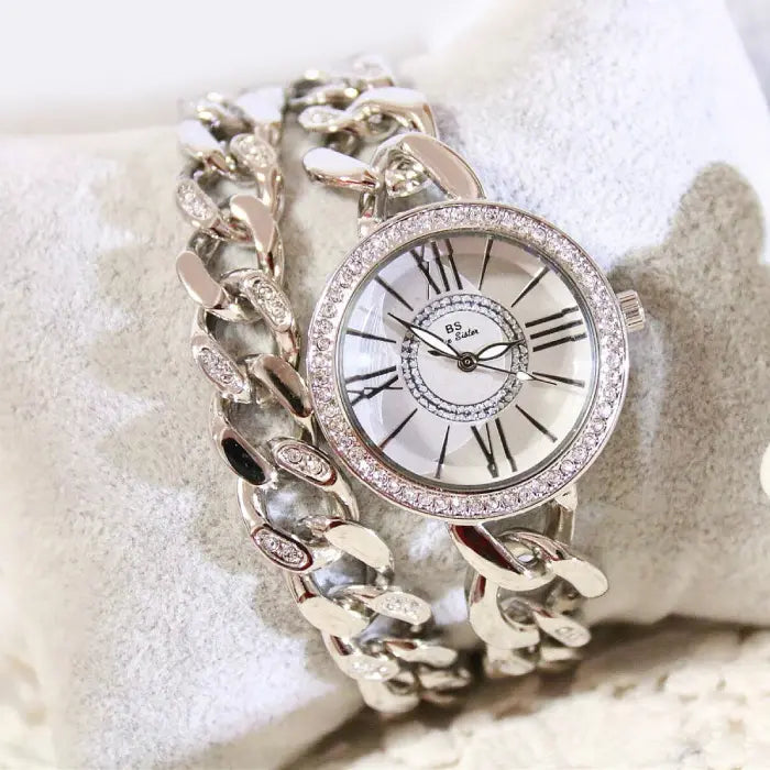 Elegant silver chain wristwatch featuring Roman numerals and crystal details for a timeless design.