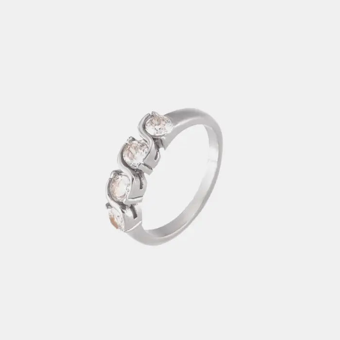 Silver ring with a twist design featuring cubic zirconia stones, on a white background.