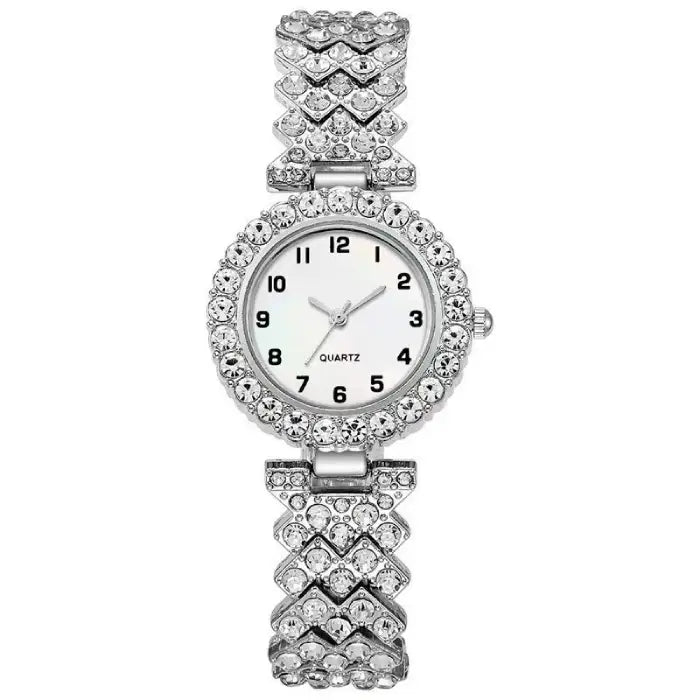 Silver quartz wristwatch with a white face and diamond like-studded chevron-patterned band.