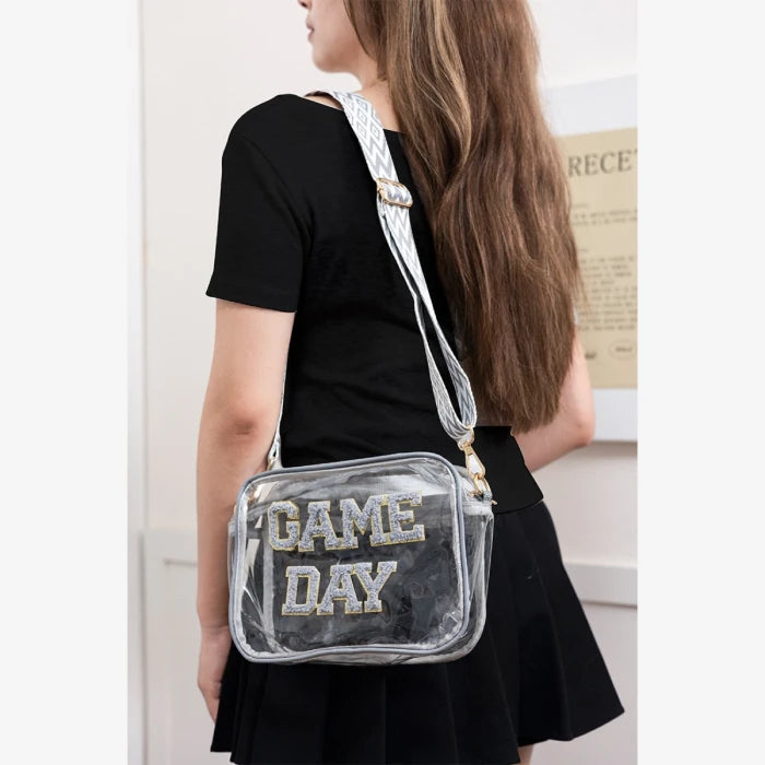 Stadium approved clear bag with silver Game Day text styled with black dress for sports event fashion