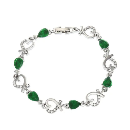 Silver bracelet with green teardrop gemstones and sparkling heart accents, classic and stylish design.