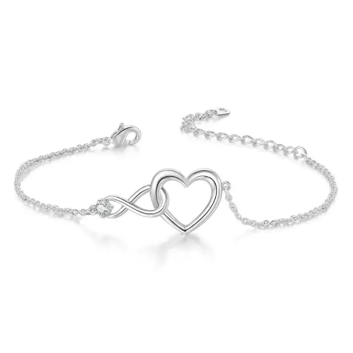 Minimalistic silver heart infinity bracelet with a dainty chain and a single sparkling diamond accent.