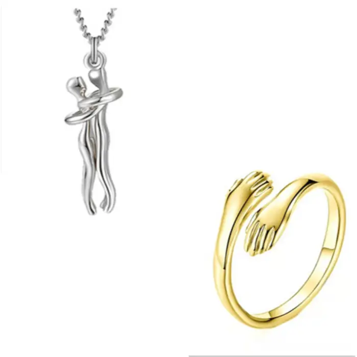 Silver couple hug pendant necklace paired with a gold hand embrace ring for symbolic romantic jewelry.