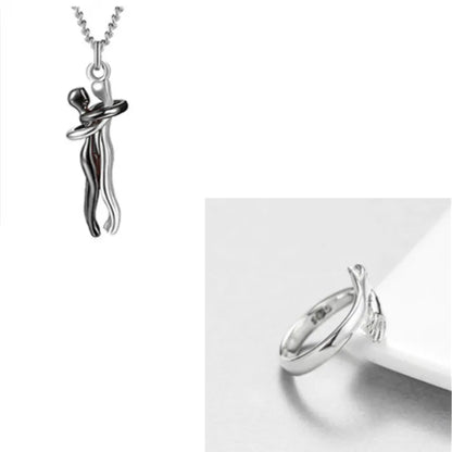 Modern abstract silver hand embrace ring paired with a silver couple pendant, perfect for romantic jewelry.