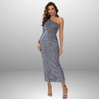 Elegant silver sequin prom dress with one-shoulder design, long sleeve, body-contouring silhouette, and floor-length sparkly finish
