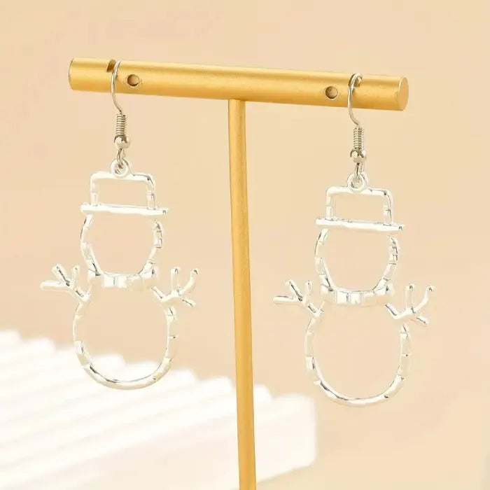 silver snowman earrings displayed on stand against beige background for holiday jewelry
