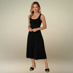 Model presents the elegant simplicity of the black sleeveless A-line midi dress with a scoop neckline. Shop this must-have casual midi dress, available with free shipping.