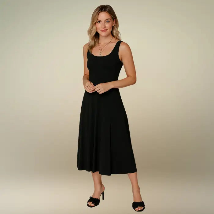 Model presents the elegant simplicity of the black sleeveless A-line midi dress with a scoop neckline. Shop this must-have casual midi dress, available with free shipping.