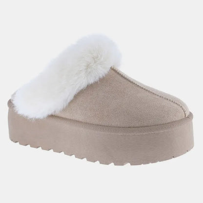 Side view of plush beige platform slipper featuring white fur collar and textured platform base for elevated comfort