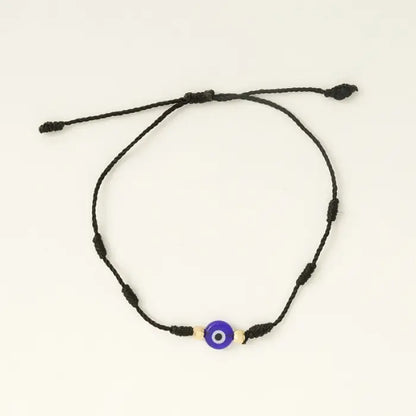 Single black adjustable evil eye bracelet with gold beads for spiritual protection and energy balance.