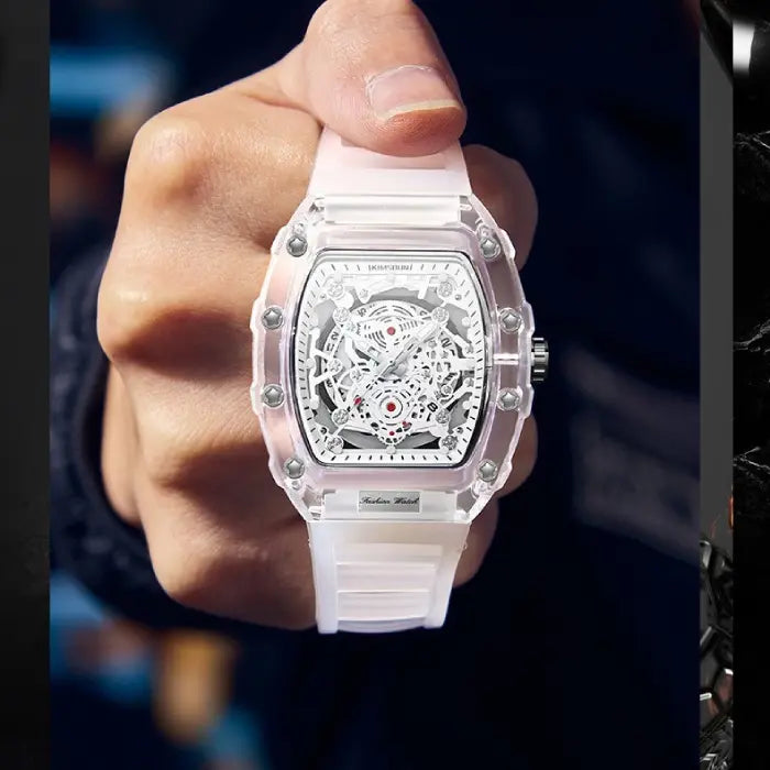 Skeleton-style mechanical wristwatch with white strap held upright for a clear front-facing view.