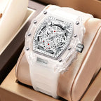 Skeleton-style mechanical wristwatch with white strap displayed in a luxury gift box setting.