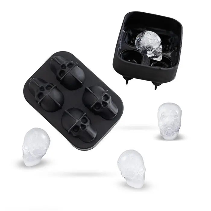 Skull ice cube silicone tray opened with four detailed mold cavities ready to fill.