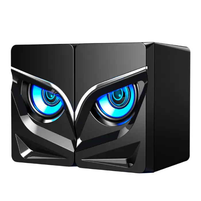 Sleek black computer speakers with blue glowing eye-like lights and angular geometric design