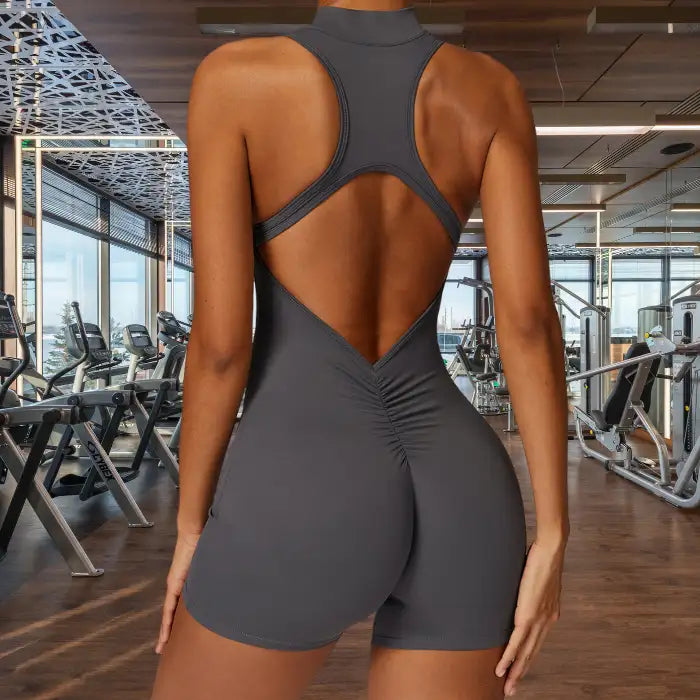 sleeveless yoga bodysuit in charcoal gray featuring diamond-shaped open back with ruched detail perfect for yoga and gym sessions