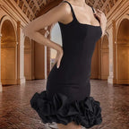 cocktail dress with sleek black silhouette, supportive straps and statement ruffle bottom photographed in elegant historical corridor