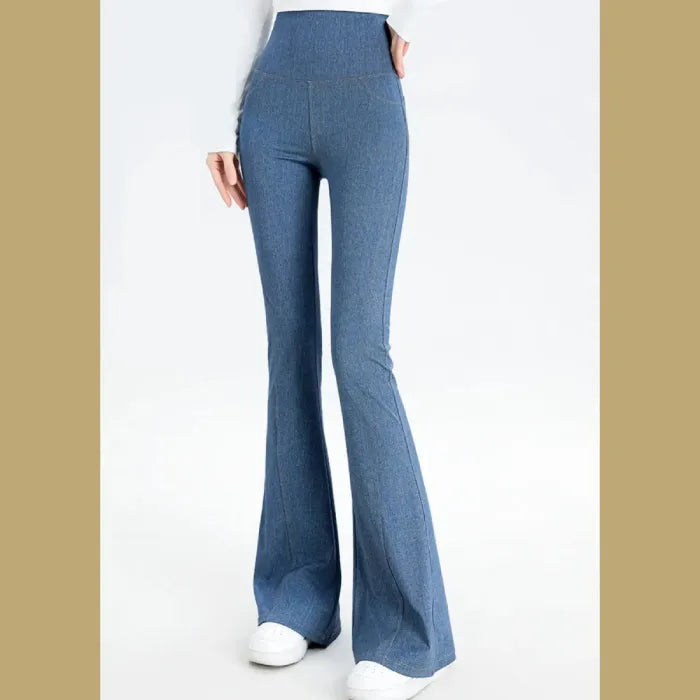 Full-length view of light blue flared denim pants with high waist, showing wide-leg design from hip to hem, paired with white shoes