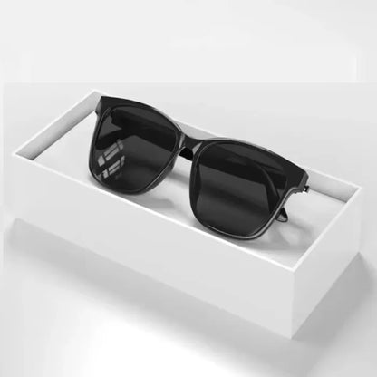 Black smart glasses displayed in box, highlighting modern wearable tech.