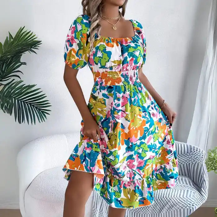 Smocked off shoulder floral midi dress vibrant green orange print highlighting smocked waist.
