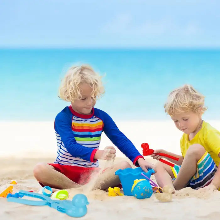 Children on the beach using snowball makers as sand molds for fun summer play