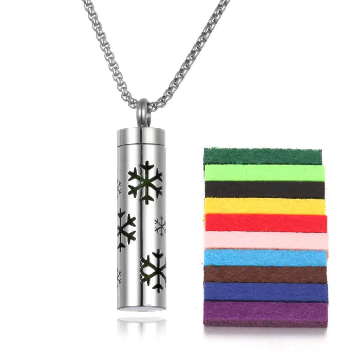 Snowflake design stainless steel aromatherapy pendant with colorful felt pads for essential oil diffusion.