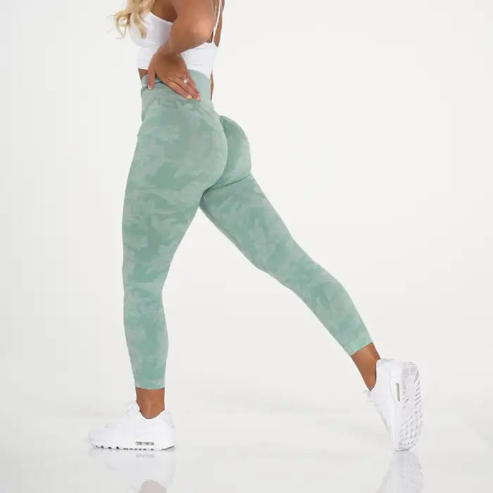 Snowflake yoga pants in mint green with smooth camo blend and curve-enhancing shape.