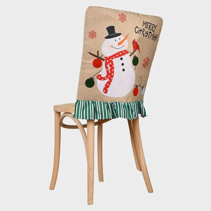 Holiday dining chair cover featuring jolly snowman, polka dot scarf, green striped ruffle trim on natural linen fabric