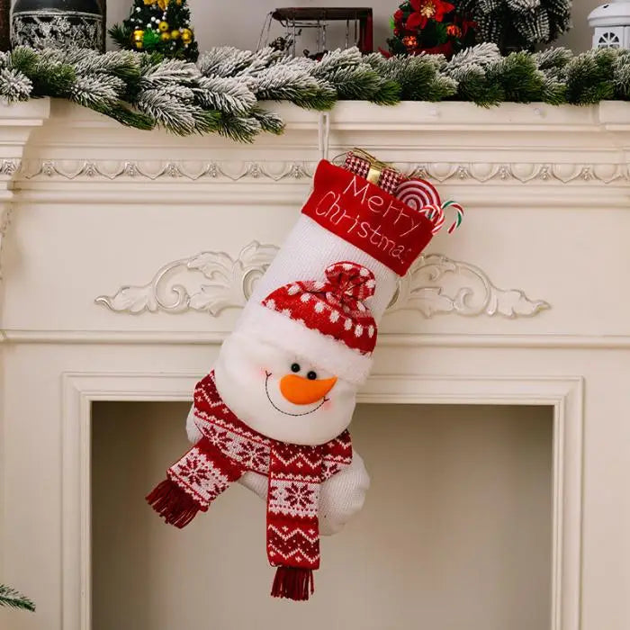 Snowman-themed Christmas stocking hanging on white fireplace mantel with festive greenery garland