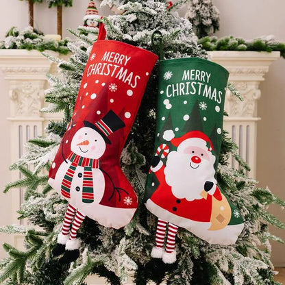 Snowman and Santa-themed Christmas stockings hanging together on a frosted tree, festive holiday decor.