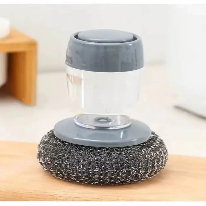 Soap-dispensing kitchen scrubber with durable metal bristles for efficient dish and surface cleaning.