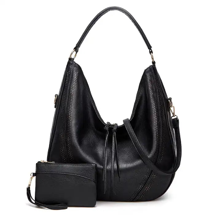 Soft leather hobo bag with perforated detail in black color, front view with matching pouch and shoulder strap.