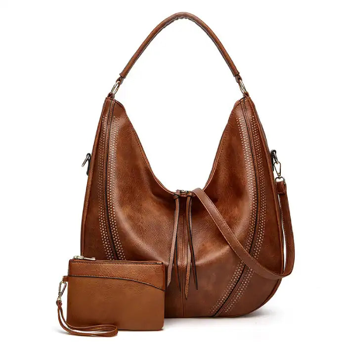Soft leather hobo bag with perforated detail in brown color, front view with matching pouch and shoulder strap.