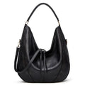 Soft leather hobo bag with perforated detail in gray color, front view with matching pouch and shoulder strap.